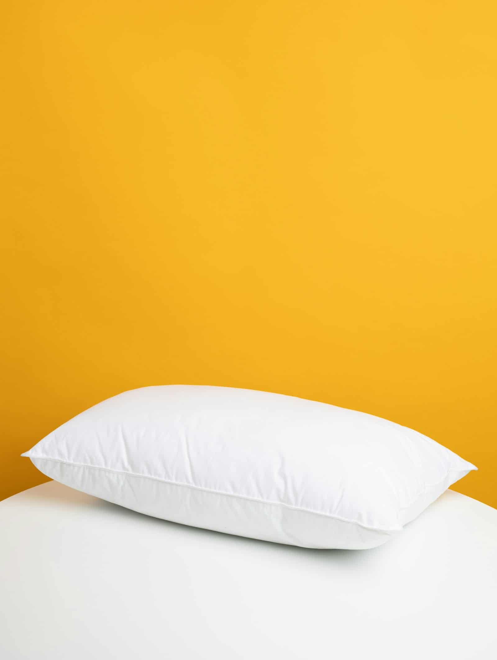 A plush white memory foam pillow, designed for ergonomic neck support and better sleep