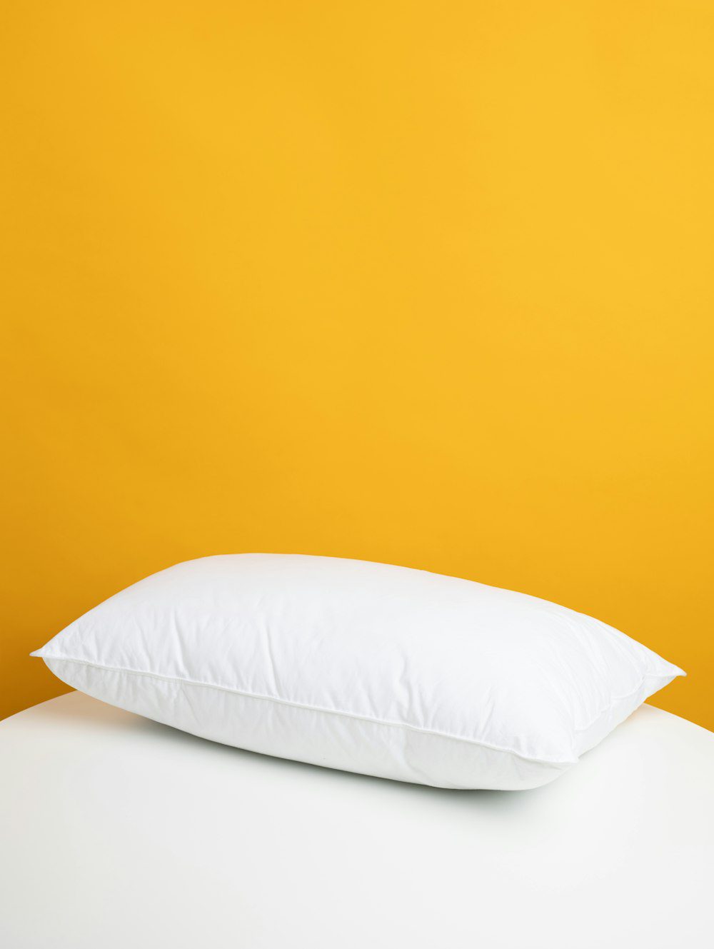 Clean white ergonomic memory foam pillow for comfortable neck and head support